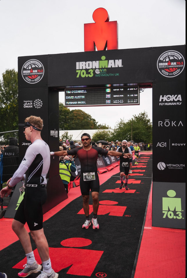 Tushar Patel crossing the finish line at Ironman 70.3 Weymouth